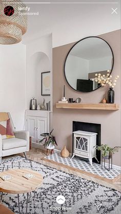 a living room filled with furniture and a fire place in the middle of the room