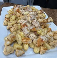 a white plate topped with chicken and potatoes