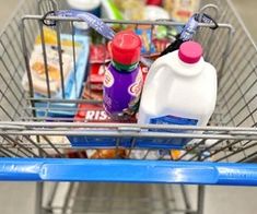 a shopping cart filled with milk and other items