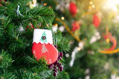 an ornament hanging from the top of a christmas tree