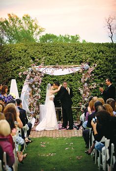 a bride and groom standing at the end of their wedding ceremony