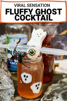 a glass jar filled with liquid and halloween decorations