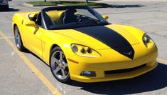 a yellow sports car parked in a parking lot