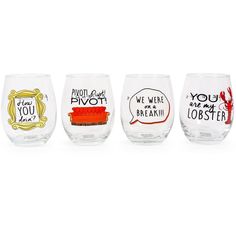 four wine glasses with different sayings on the side and one has a red ribbon