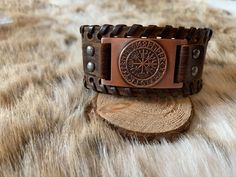 Leather Cuff Bracelet featuring different symbols from Norse Mythology Adjustable Symbolic Cuff Bracelet, Symbolic Stamped Cuff Bracelet, Viking Style Handmade Bracelets As Gift, Handmade Viking Style Bracelets For Gifts, Brown Stamped Cuff Bracelets, Brown Stamped Cuff Bracelet, Viking Style Adjustable Bracelet Gift, Viking Style Bangle Bracelets, Adjustable Viking Style Bracelet As Gift