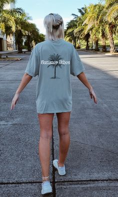 "summer vibes oversized comfort colors top | sunkissed beach tees | hot summer tees | hipster beach crewneck | 2023 summer crewneck | VSCO Introducing our Comfort Colors Crewneck with the fun and playful text \"Summer Vibes\". This oversized tee is the perfect addition to your summer wardrobe for the 2023 season. Whether you're a hipster, surfer, or just looking for a comfortable and stylish outfit, this crewneck is the perfect fit. Made with high-quality materials, this crewneck features an oversized fit that adds a relaxed and laid-back feel to your outfit. The \"Summer Vibes\" text adds a fun and carefree touch to your look, reminding you to enjoy the sun and embrace the spirit of the season. Designed to keep you comfortable in the hottest summer weather, this crewneck is made from the Beachy Tees, Comfy Summer Fits, Summer Nyc Outfits, Oversized Tee Outfit, Beach Tees, Nyc Outfits Summer, Summer Work Outfits Office, Beach Crewneck, Church Outfit Casual