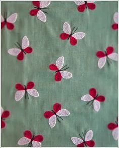 red and white butterflies on green fabric