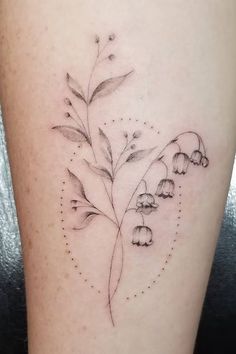 a tattoo with flowers on the side of a woman's leg, which is drawn in black ink