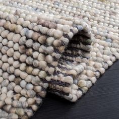 an area rug that has been made to look like it is covered in balls and yarn