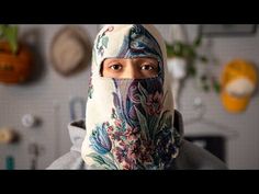 a woman wearing a headscarf in a kitchen