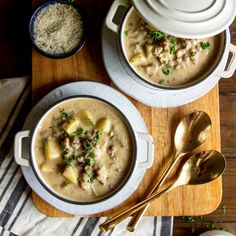 two bowls filled with soup on top of a wooden table