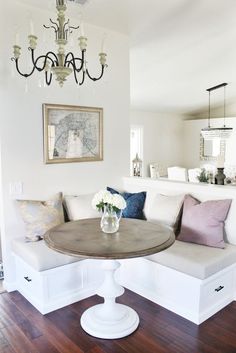 a living room filled with furniture and a chandelier