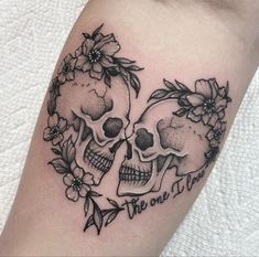 two skulls with flowers on their heads and the words be one in love written below them