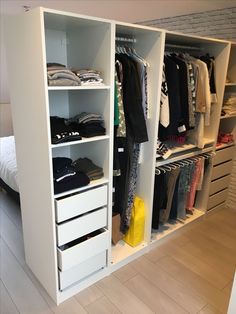 a white closet filled with lots of clothes