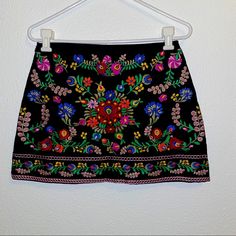 Bold Embroidery Flower Pattern, On Black Fabric Excellent Condition! Sewn In Liner 14” Hip To Hip 14” Long 6 1/2” Side Zip Bohemian Embroidered Fitted Mini Skirt, Fitted Bohemian Embroidered Mini Skirt, Bohemian Fitted Mini Skirt With Floral Embroidery, Multicolor Floral Embroidered Skirt For Festivals, Embroidered Black Skirt For Summer, Floral Embroidered Festival Skirt, Traditional Embroidered Black Skirt, Traditional Black Embroidered Skirt, Fitted Skirt With Multicolor Floral Embroidery