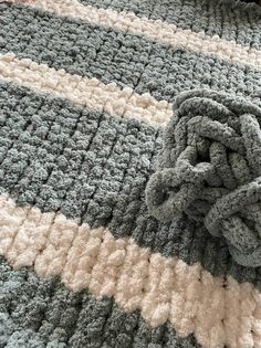 a crocheted blanket laying on top of a bed