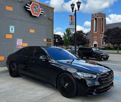 a black car parked in front of a building