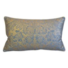 a blue and gold pillow on a white background