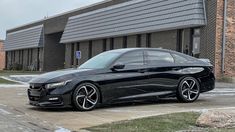 a black car parked in front of a building