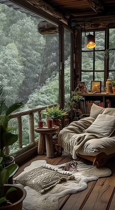 a couch sitting on top of a wooden floor next to a window covered in plants