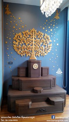 a room with blue walls and wooden steps that are decorated with gold leaf designs on the wall