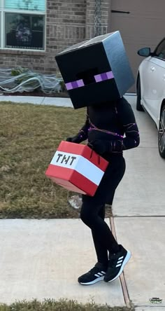 a person in a costume with a box on their head and a bag over his shoulder