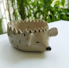 a ceramic hedgehog bowl sitting on top of a table