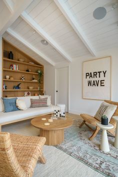 a living room filled with furniture and a painting on the wall above it that reads party wave