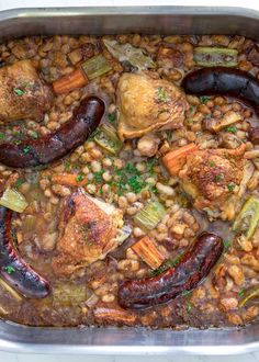 a pan filled with beans, meat and vegetables