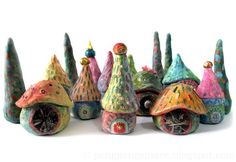 there are many small colorful houses made out of clay and painted with acrylic paint