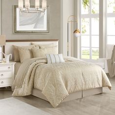 a bedroom with white furniture and beige bedding in it's centerpieces