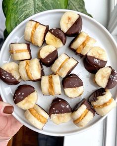 a white plate topped with chocolate covered bananas