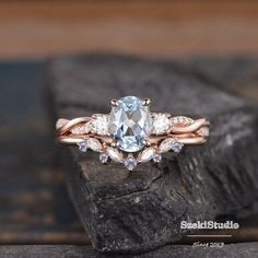 a blue topazte and diamond engagement ring on a rock