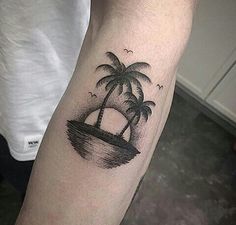 a small palm tree tattoo on the arm