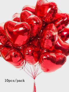 a bunch of red heart shaped balloons