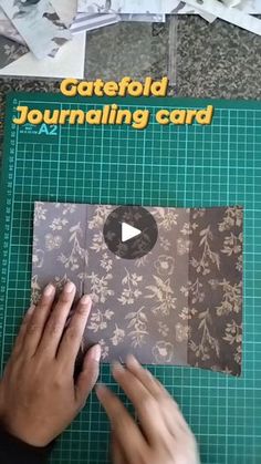 someone is cutting out the pattern for a card with scissors and glue on it,