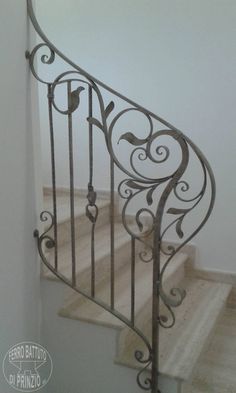 an iron stair railing in a white room