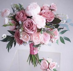 a bouquet of pink flowers sitting on top of a table