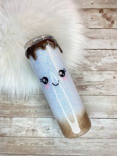 a blue and gold glitter tumbler with a smiling face on it