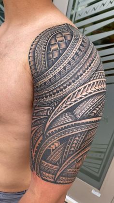 a man with a large tattoo on his arm