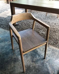 a wooden chair sitting in front of a table