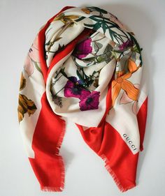 GUCCI Brand: GUCCI Main color: ivory, red, multi Details: Emblematic of Gucci's contemporary sophistication, this wool and silk scarf features the iconic Flora print. Designed in 1966 by Rodolfo Gucci, the son of the fashion house's founder, this eternal floral motif celebrates women's strength and beauty. As a unique touch to a refined outfit, or for a happy blend of prints, this scarf combines tradition and modernity. Enriched by a floral graphic print with logo.  Red border Also features frin Elegant Gucci Silk Scarves, Designer Gucci Silk Scarves, Luxury Gucci Silk Scarves, Luxury Gucci Scarves For Fall, Gucci Luxury Winter Scarf, Gucci Luxury Winter Scarves, Luxury Gucci Scarf For Winter, Luxury Gucci Scarves For Winter, Luxury Gucci Winter Scarves