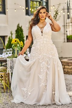 a woman in a wedding dress is posing for the camera