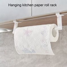 a roll of toilet paper hanging on a kitchen wall rack above a sink with the words hanging kitchen paper roll rack over it