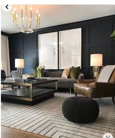 a living room filled with furniture and a chandelier hanging from the ceiling in front of two windows