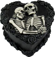 a heart shaped cake decorated with two skeletons