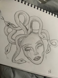 a drawing of a woman's face with snakes around her head