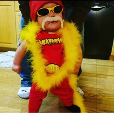 a baby dressed up in a costume and sunglasses