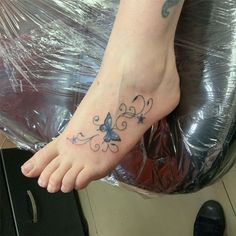 a person with a butterfly tattoo on their foot