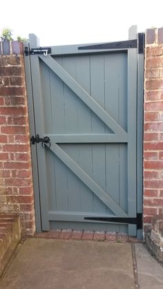 an open gate on the side of a brick building